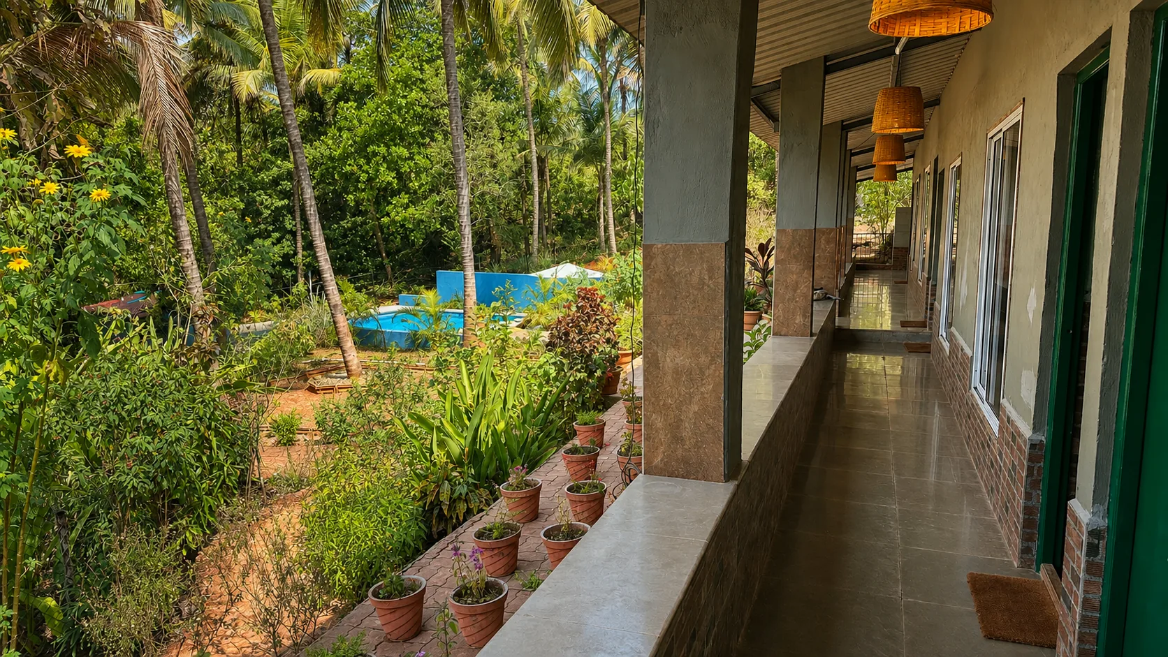 Guest-room veranda overlooking the tropical gardens and swimming pool at The Haven Goa